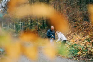 a couple in the forrest in autumn